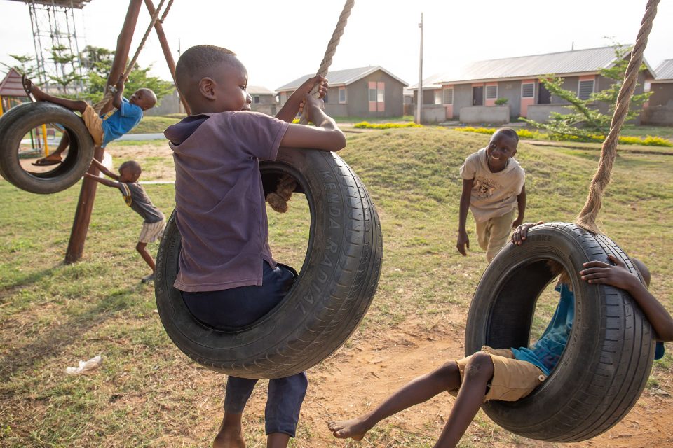 Boys playing on tyre swings