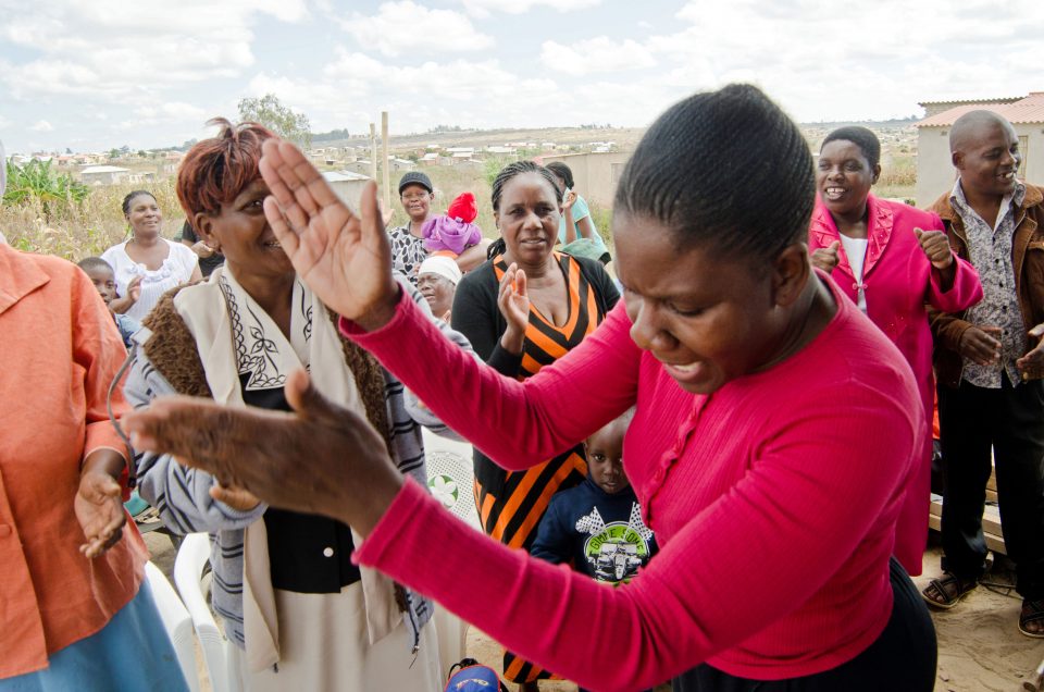 Lady clapping hands in celebration at a outdoor event