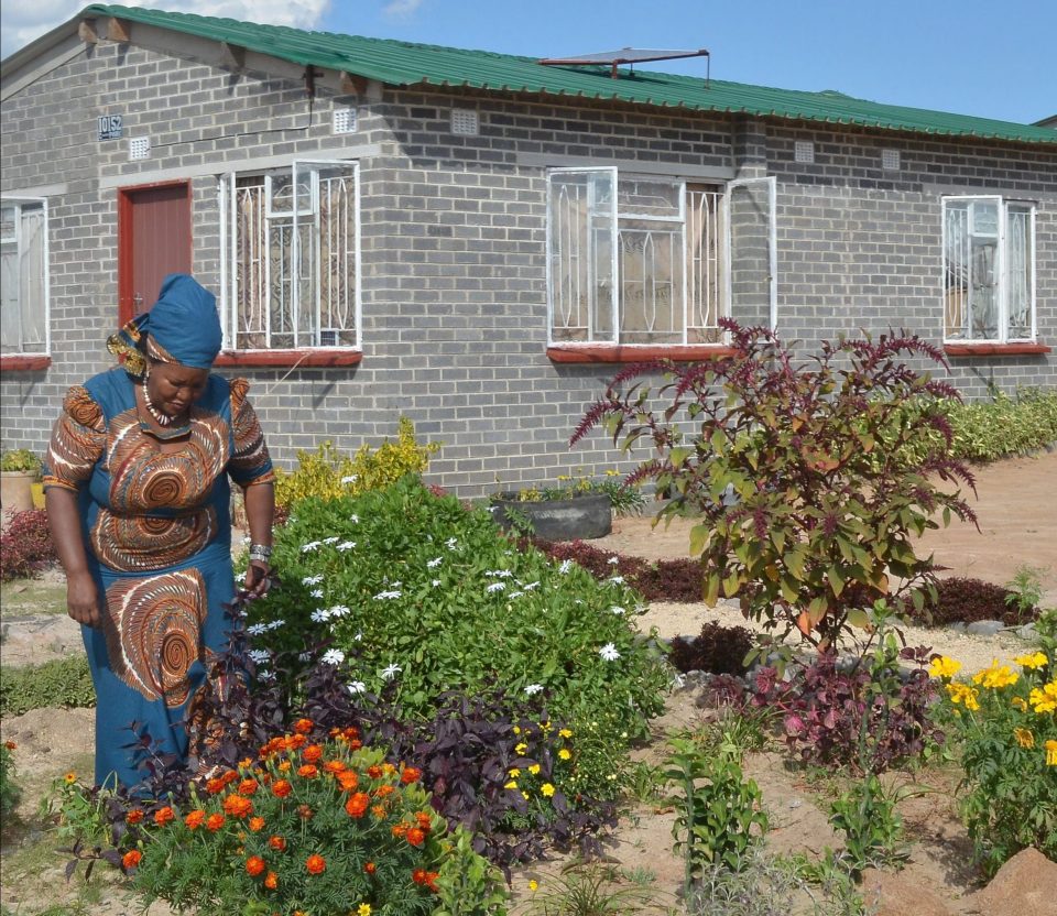 Lady gardening outside her affordable home