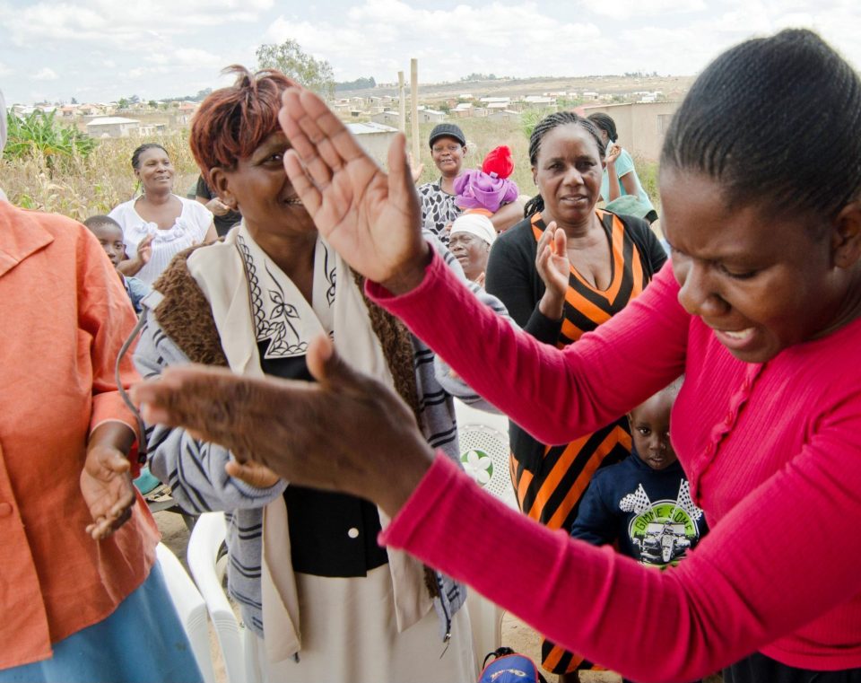Lady clapping hands in celebration at a outdoor event